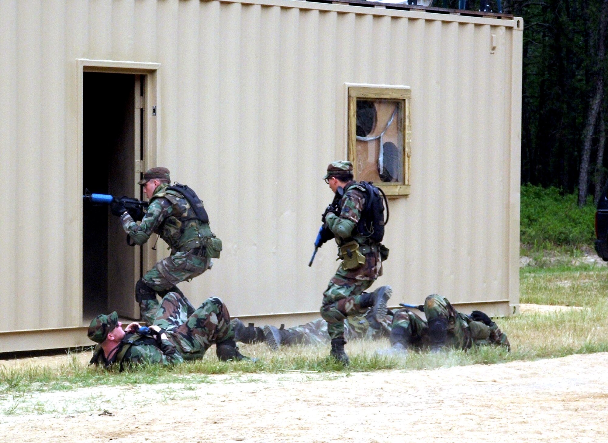 Students practice urban tactics during Air Force Integrated Contingency Skills Training Course 06-4 at Naval Air Engineering Station Lakehurst, N.J., on Thursday, June 22. More than 165 students are participating in the course. Students also learn convoy training in preparation for deployments. The training is taught by staff at the Air Mobility Warfare Center's 421st Combat Training Squadron. (U.S. Air Force photo/Tech. Sgt. Scott T. Sturkol)