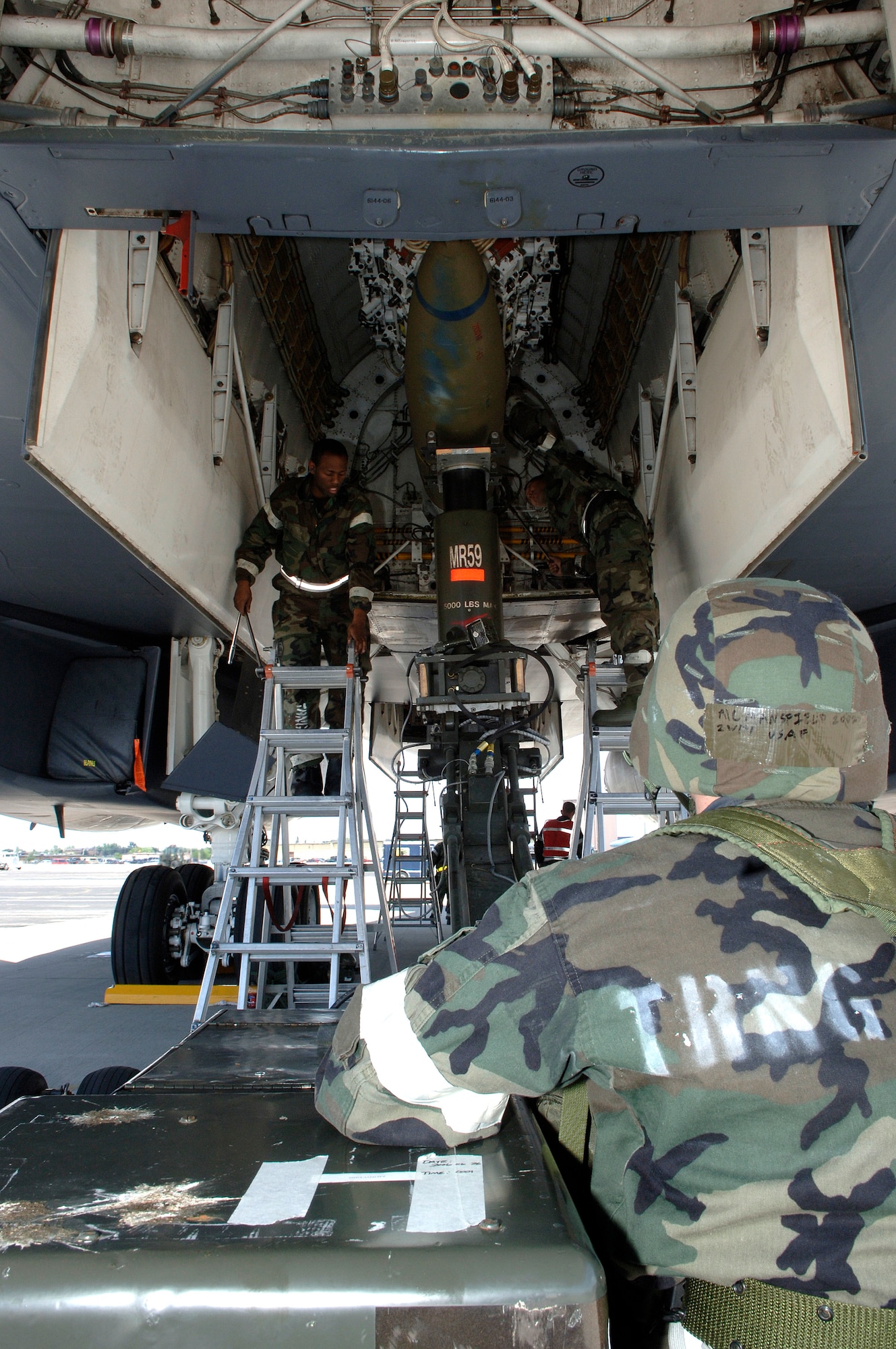 Aircraft maintenance troops secure a training bomb into the bay of a B-1 Lancer at Ellsworth Air Force Base, S.D., on Monday, June 26. The base is conducting Exercise Badlands Express 06-04 to prepare for an operational readiness inspection in July. The Airmen are assigned to the 28th Aircraft Maintenance Squadron. (U.S. Air Force photo/Senior Airman Michael B. Keller) 

