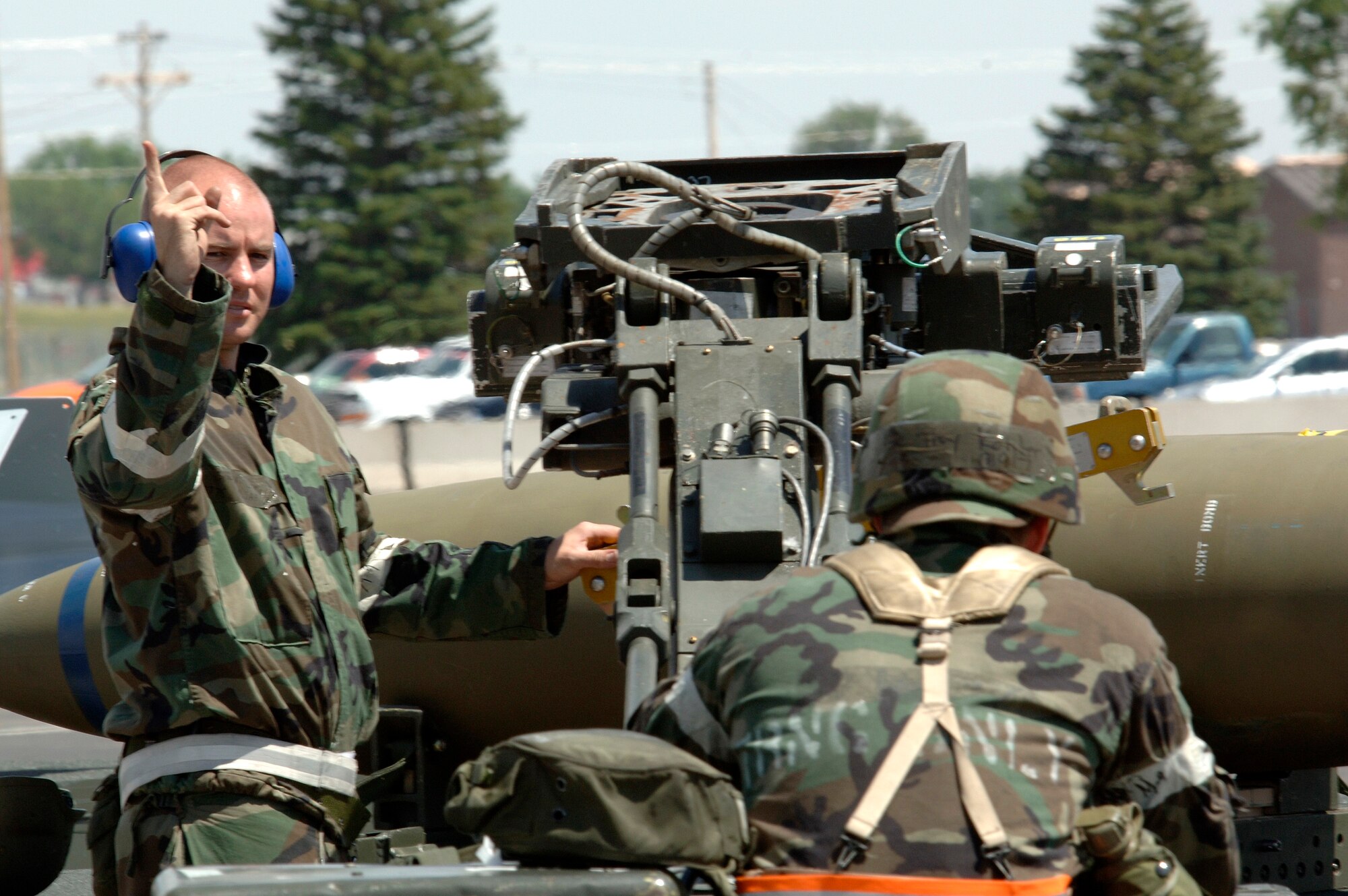 Senior Airman Ryan McGlocklin (left) and Airman 1st Class Eric Mansfield prepare to load a training bomb into the bay of a B-1 Lancer at Ellsworth Air Force Base, S.D., on Monday, June 26. The base is conducting Exercise Badlands Express 06-04 to prepare for an operational readiness inspection in July. The Airmen are assigned to the 28th Aircraft Maintenance Squadron. (U.S. Air Force photo/Senior Airman Michael B. Keller) 
