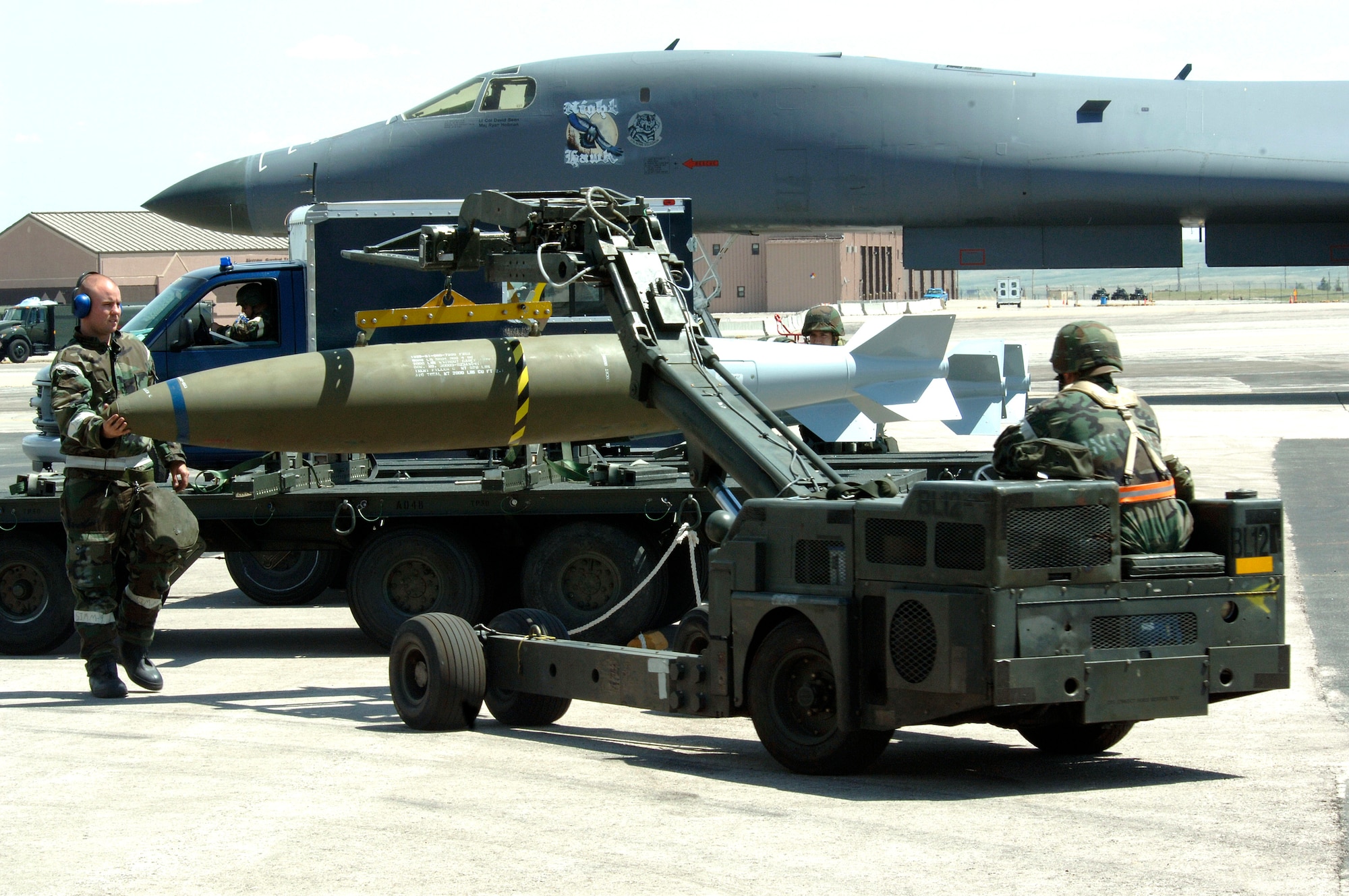 Senior Airman Ryan McGlocklin (left) and Airman 1st Class Eric Mansfield prepare to load a training bomb into the bay of a B-1 Lancer at Ellsworth Air Force Base, S.D., on Monday, June 26. The base is conducting Exercise Badlands Express 06-04 to prepare for an operational readiness inspection in July. The Airmen are assigned to the 28th Aircraft Maintenance Squadron. (U.S. Air Force photo/Senior Airman Michael B. Keller)
