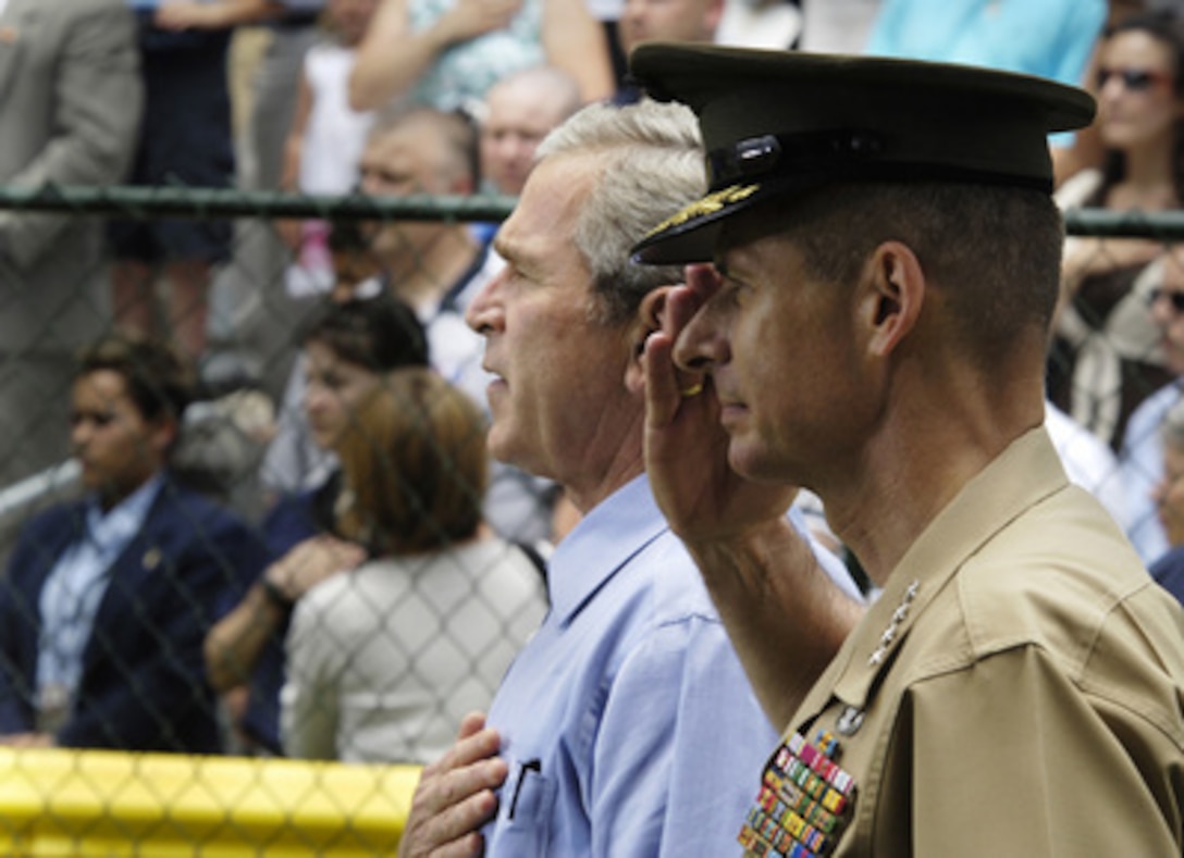 President George W. Bush and Chairman of the Joint Chiefs of Staff Gen. Peter Pace, U.S. Marine Corps, salute during the playing of the national anthem during the first tee ball game of the 2006 season on the White House South Lawn in Washington, D.C., on June 23, 2006. 