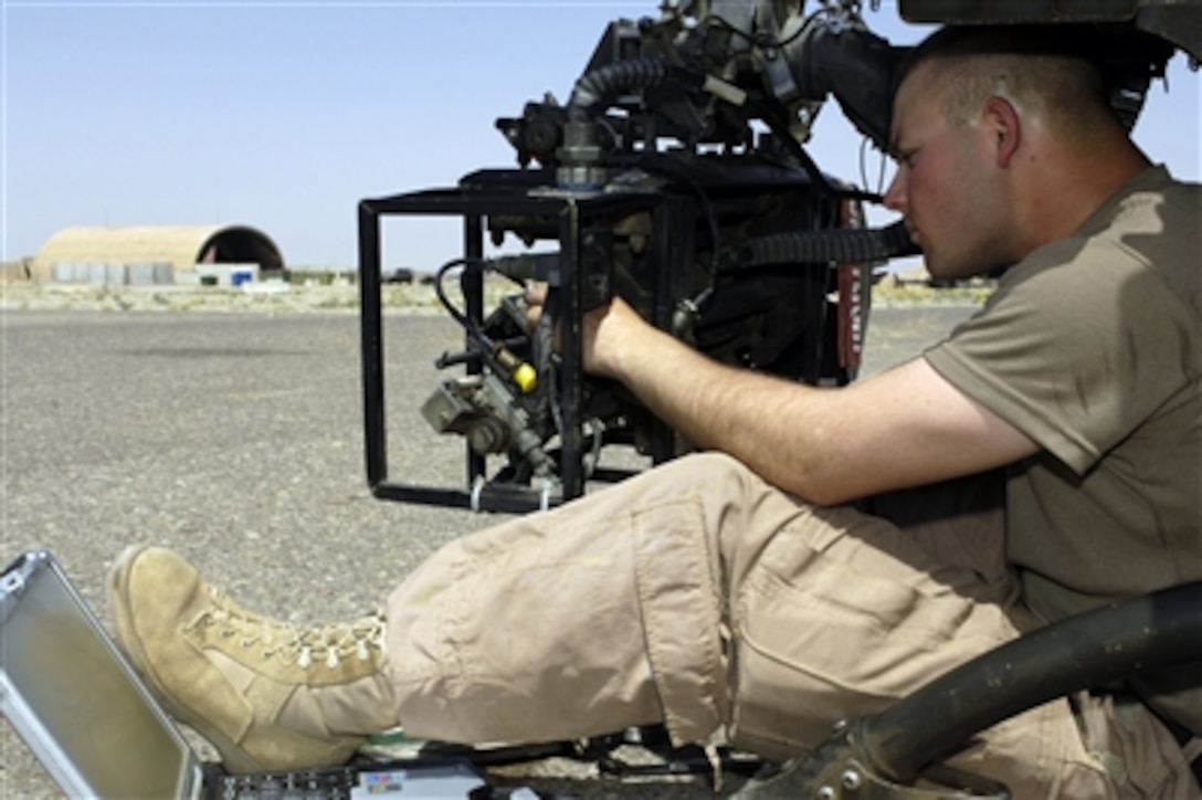 U.S. Army Spc. Stephen Morris, from 2nd Squadron, 17th Cavalry Regiment, troubleshoots a faulty magnetic round counter on an aviation-modified .50-caliber M2 weapon system from an OH-58D Kiowa helicopter at Forward Operating Base Warrior, Iraq, June 24, 2006.