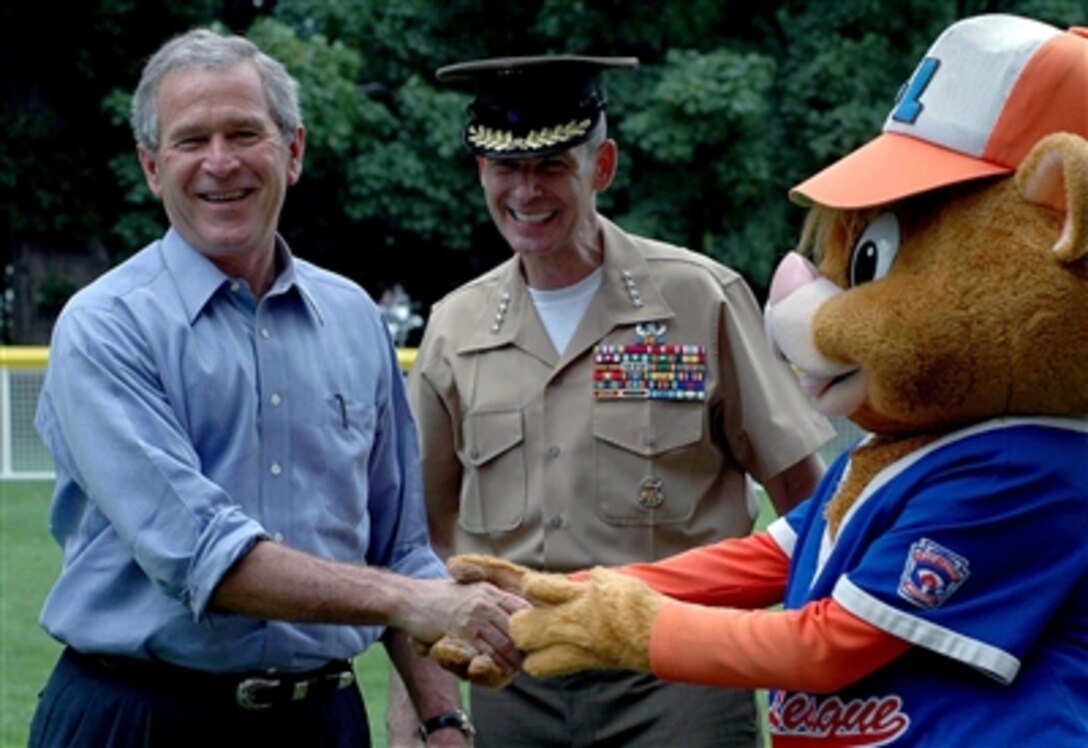President Bush and Joint Chiefs Chairman Gen. Peter Pace share a lighter moment with “Dugout” the mascot. The McGuire Air Force Base Yankees faced off against the Dolcom Little League Indians during the White House T-Ball game on the South Lawn, June 23, 2006.