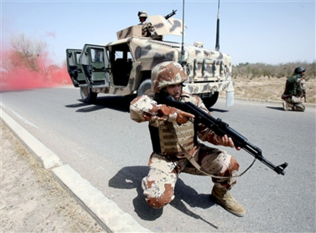 Iraqi soldiers react to a simulated vehicle breakdown during a training exercise to test the Mobile Tracking System Lite at Camp Baharia, Iraq, June 18, 2006. They took another step closer to independent operations when they completed testing and evaluation of the new tracking and communications system for their convoys.