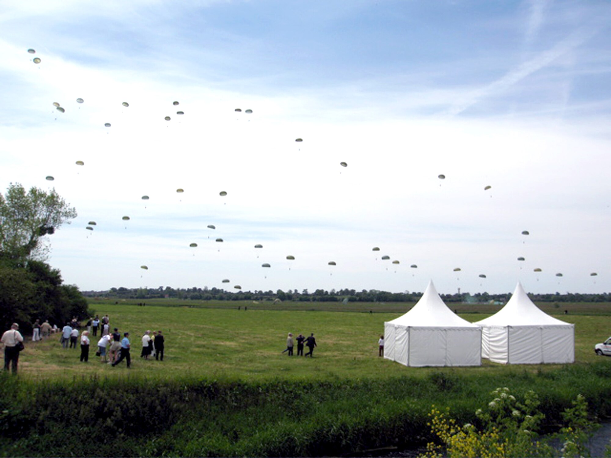 Paratroopers land in a drop zone as part of observances for the 62nd anniversary of D-Day in Normandy, France, on June 4. The paratroopers were a combined force from the U.S., Canada, France, Britain and Germany participating in Operation Airdrop Warrior 2006. The airdrop event was held two days before the actual anniversary. (Courtesy photo/Bruno Konieczy)