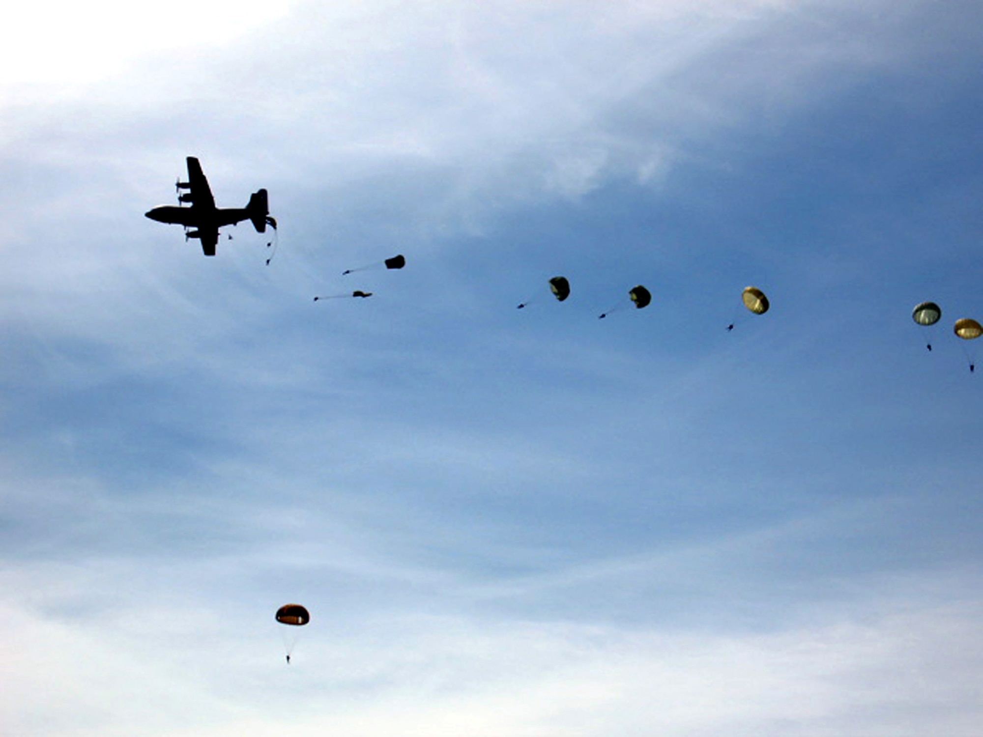 Paratroopers jump out of a C-130 Hercules as part of observances for the 62nd anniversary of D-Day in Normandy, France, on June 4. The paratroopers were a combined force from the U.S., Canada, France, Britain and Germany participating in Operation Airdrop Warrior 2006. The airdrop was held two days before the actual anniversary. (Courtesy photo/Bruno Konieczy)