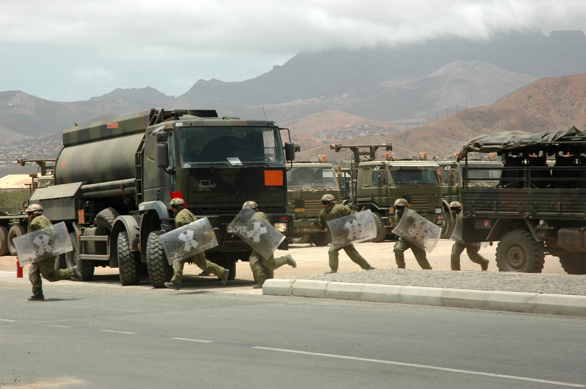 A German force protection platoon prepares to fend off simulated rioters during NATO's Exercise Steadfast Jaguar in Sao Vicente, Cape Verde, on Friday, June 23. The purpose of the exercise is to test NATO's ability to project a force a strategic distance from mainland Europe and sustain it. The riot scenario demonstrated the German platoon's crowd control and riot training. (U.S. Air Force photo/Capt. Krista Carlos) 