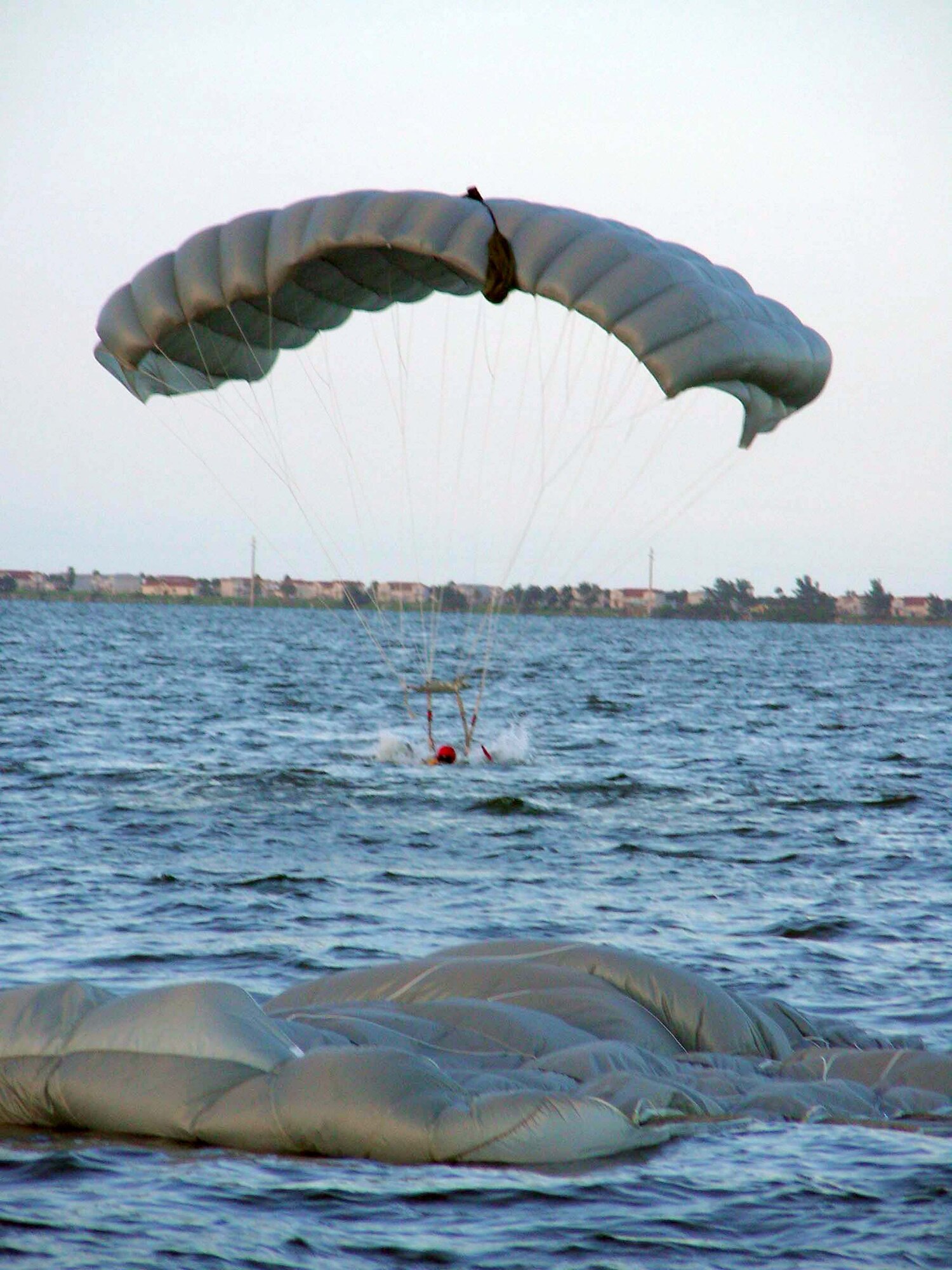 A pararescueman from the 920th Rescue Wing lands in the Banana River near Patrick Air Force Base, Fla., on Friday, June 23. He and other PJs were participating in open water rescue and recovery training to prepare them for space shuttle launch recovery support. (U.S. Air Force photo/1st Lt. Cathleen Snow) 

