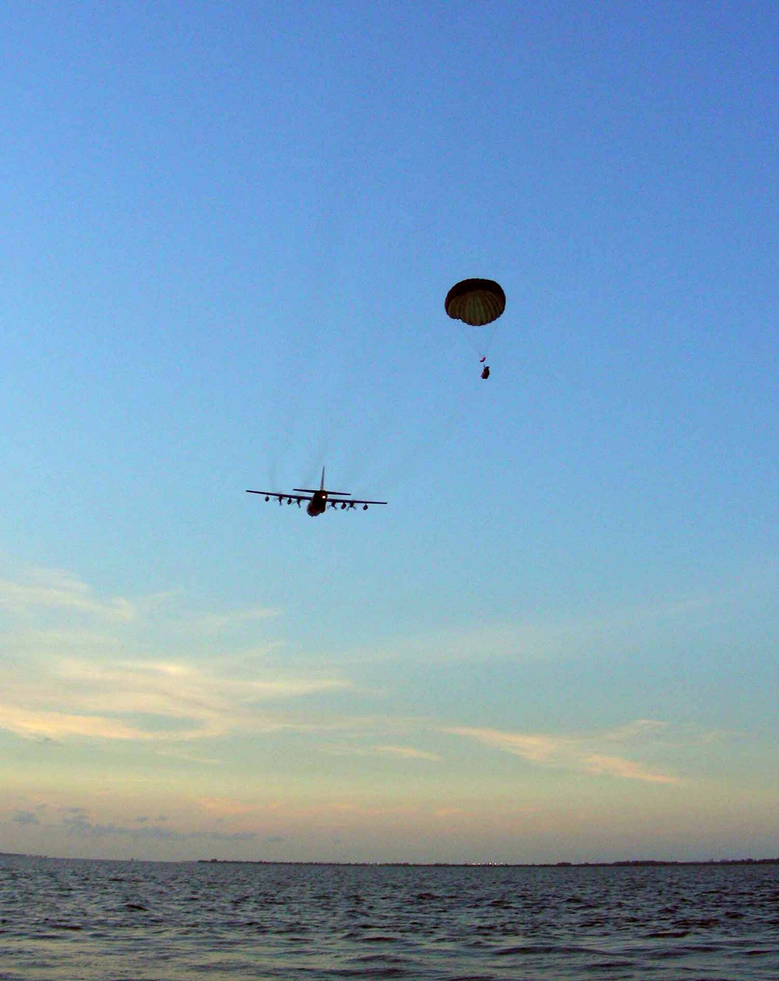 Crews from the 920th Rescue Wing deploy a motorized inflatable boat from an HC-130 aircraft over the Banana River near Patrick Air Force Base, Fla., on Friday, June 23. The pararescuemen were training in open water rescue and recovery techniques to prepare them for space shuttle launch recovery support. (U.S. Air Force photo/1st Lt. Cathleen Snow) 
