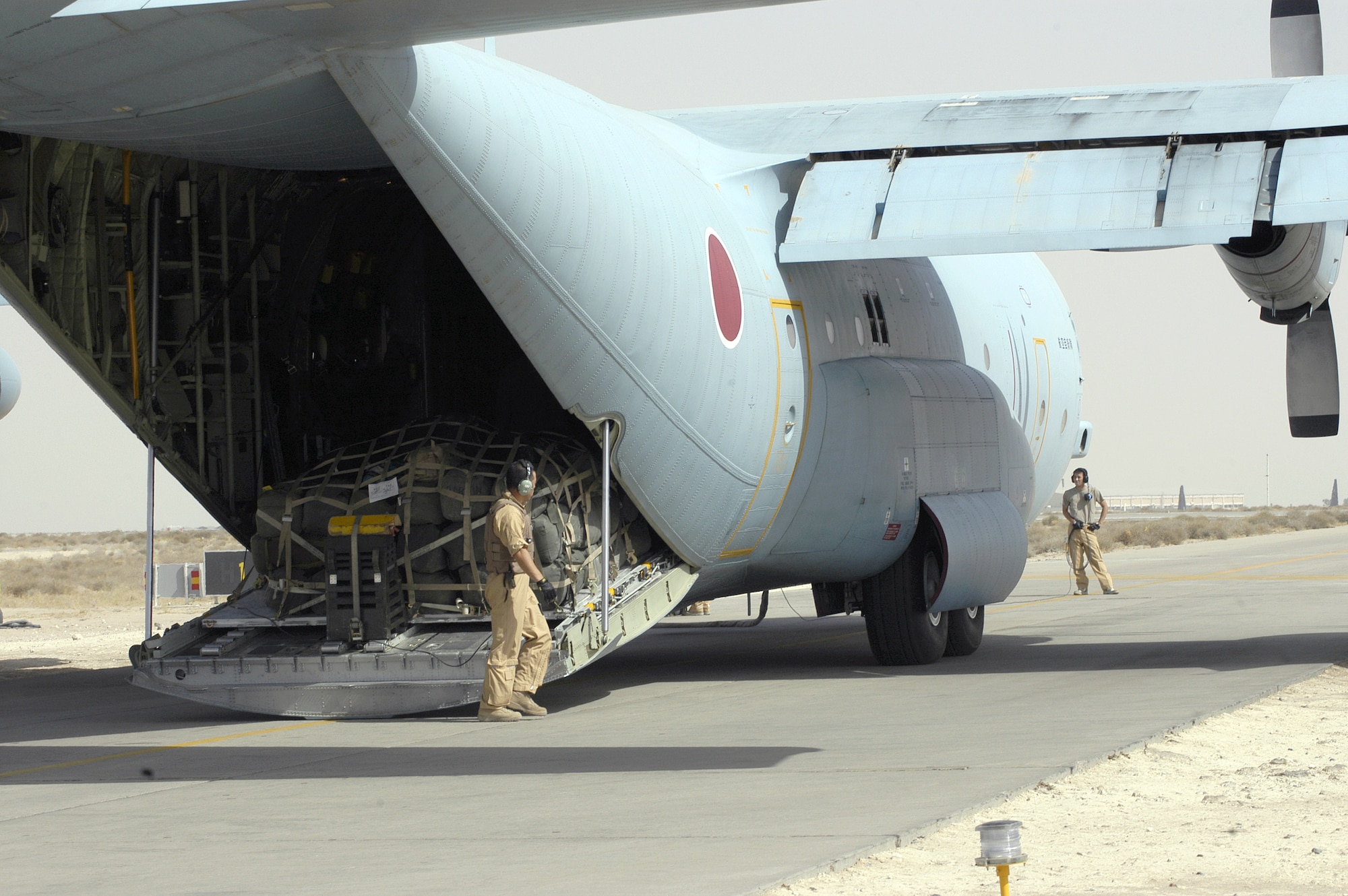 Aircrew from the Japan Air Self-Defense Force load and pre-flight one of their C-130s before a mission in Southwest Asia. (U.S. Air Force photo/Staff Sgt. Ryan Hansen) 
