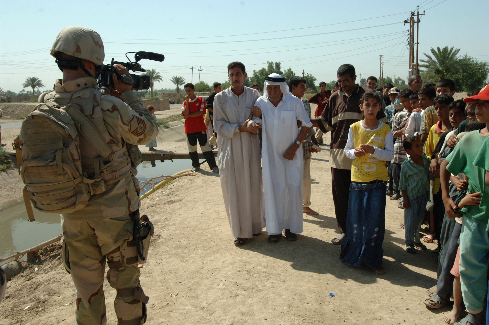 Master Sgt. Christopher Nolan videotapes Iraqi citizens during an Army exercise conducted in Baghdad, Iraq, on Saturday, June 24. Sergeant Nolan is a combat videographer with the 1st Combat Camera Squadron at Charleston Air Force Base, S.C. (U.S. Army photo by Staff Sgt. Kevin L. Moses Sr.)