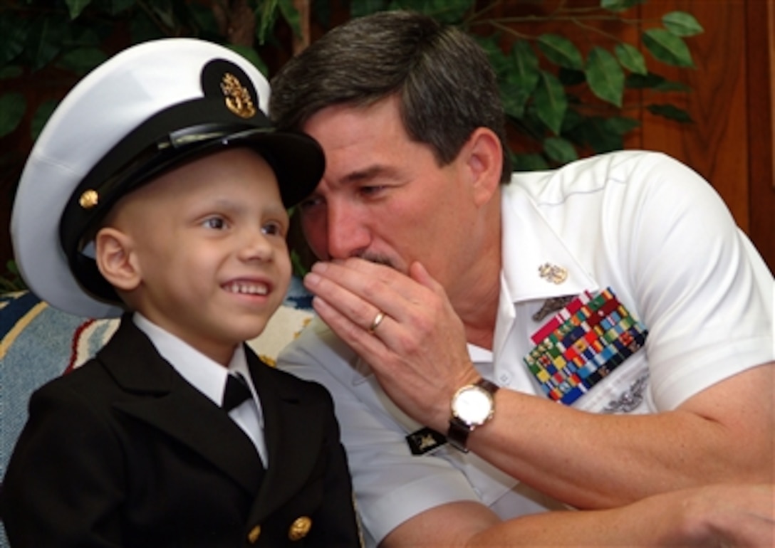 Master Chief Petty Officer of the Navy Terry Scott exchanges a few secrets with 7-year-old Honorary Chief Hospital Corpsman Diego Santiago during an office call at the Navy Annex in Arlington, Va., June 2, 2006. Last year Santiago was diagnosed with lung cancer, and his wish was to become a chief just like his father. His wish became a reality during a March pinning ceremony in Jacksonville, Fla.
