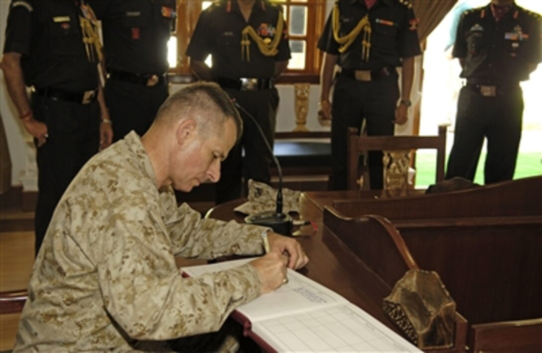 Chairman of the Joint Chiefs of Staff U.S. Marine Gen. Peter Pace signs a guest book at an Indian Army museum in Shimla, India, June 6, 2006.