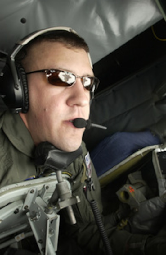 U.S. Air Force Senior Airman Corrie Elmes mans the refueling boom as he refuels an F-22A Raptor aircraft while flying in a KC-135R Stratotanker aircraft en route to Elmendorf Air Force Base, Alaska, on June 23, 2006. The aircraft will be participating in exercise Northern Edge 2006. Elmes is attached to the168th Air Refueling Wing. 