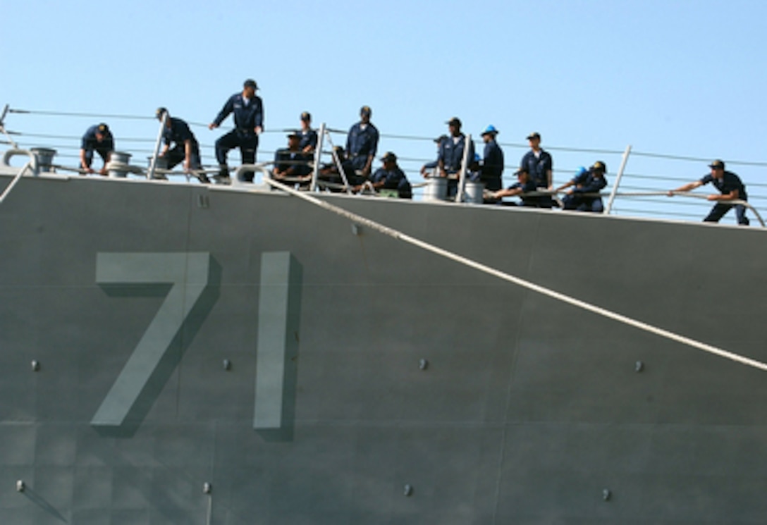 U.S. Navy sailors aboard the guided missile destroyer USS Ross (DDG 71) heave around on the mooring lines as the ship ties up to the pier in Souda Bay in Crete, Greece, on June 25, 2006. Ross is in Souda Bay for a port visit during its deployment. 