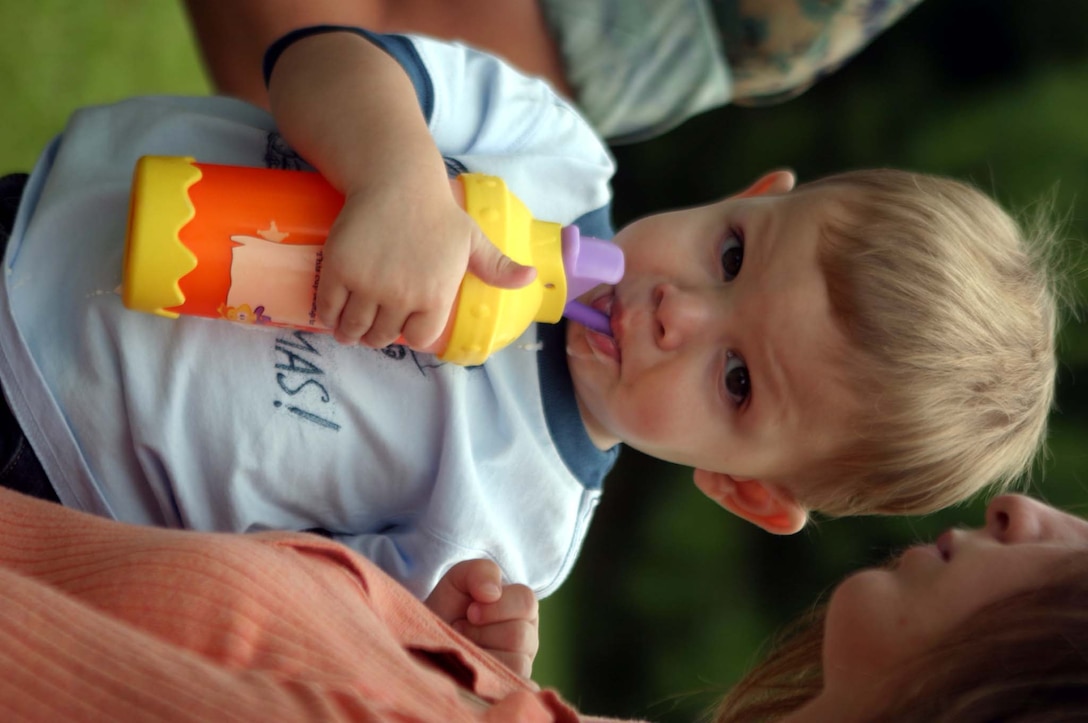 MARINE CORPS BASE CAMP LEJEUNE, N.C. (June 29, 2006) ?  Gavin Schuck, son of fallen combat engineer Cpl. Brandon Schuck, sits in his mother?s arms, June 29. Schuck was presented savings bonds valued at $20,000 by the Marine Corps-Law Enforcement Foundation to put toward his college education. Schuck was killed in action, Feb. 6, in Baghdadi, Iraq, while conducting combat operations and was with 8th Engineer Support Battalion, 2nd Marine Logistics Group.