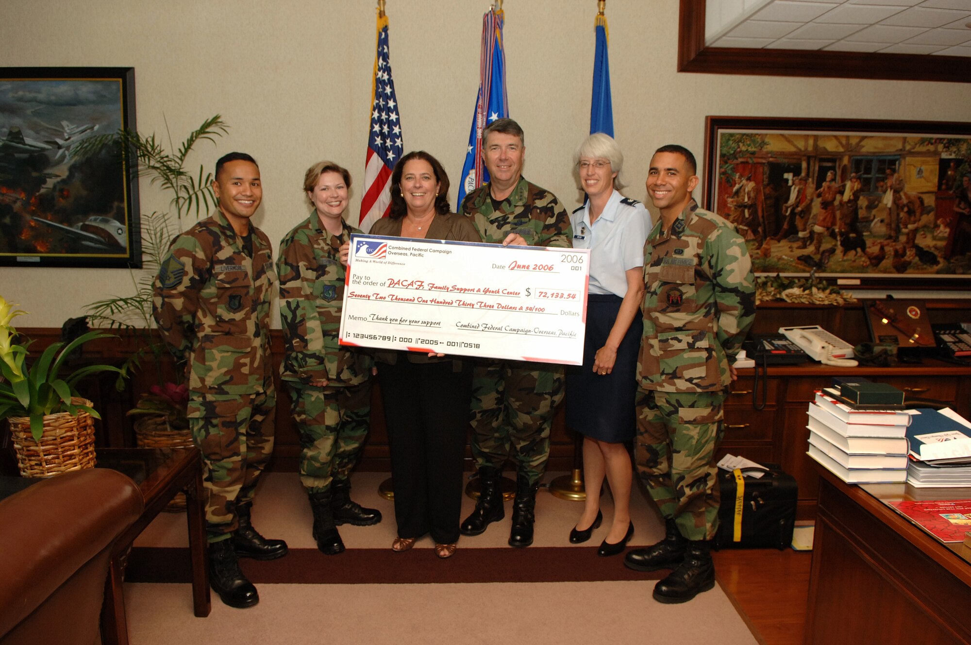 HICKAM AIR FORCE BASE, Hawaii -- General Paul V. Hester, Commander, Pacific Air Forces accepts a check for $71,133.54 from Renee Acosta, CEO of Global Impact and manager of the Combined Federal Campaign for overseas locations.  

The money, donated by Airmen stationed at Air Force installations in Japan, Korea, and Guam, will directly fund programs supervised by their family support and youth services organizations.  Because of their international locations CFC funds collected are given directly back to the bases.  Also pictured are 2005 PACAF CFC coordinators; Senior Master Sgt. Michael Livermore, Capt. Heather Thompson, Lt. Col. Karla Moyer, Capt. Wallace Reed

The CFC 2006 Campaign will begin in mid September.

(U.S. Air Force photo by Mark Bates)