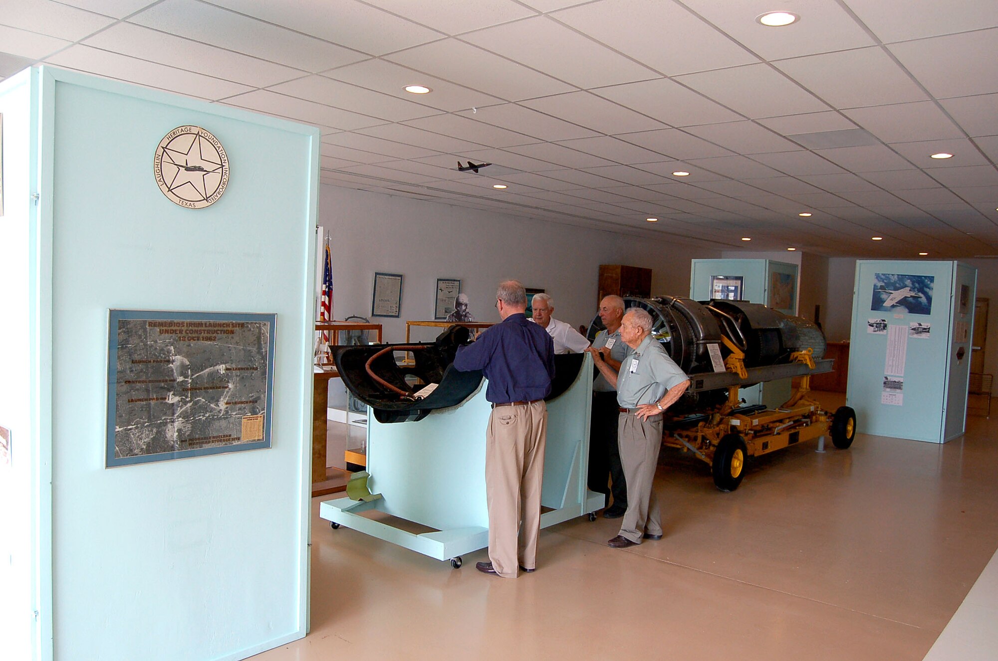 Members of the Laughlin Heritage Foundation gather around an exhibit at the Laughlin Heritage Foundation Museum in Del Rio, Texas, on Tuesday, June 27. The museum has been open for six months and is run by volunteers. (U.S. Air Force photo/Staff Sgt. Jeremy Larlee) 

