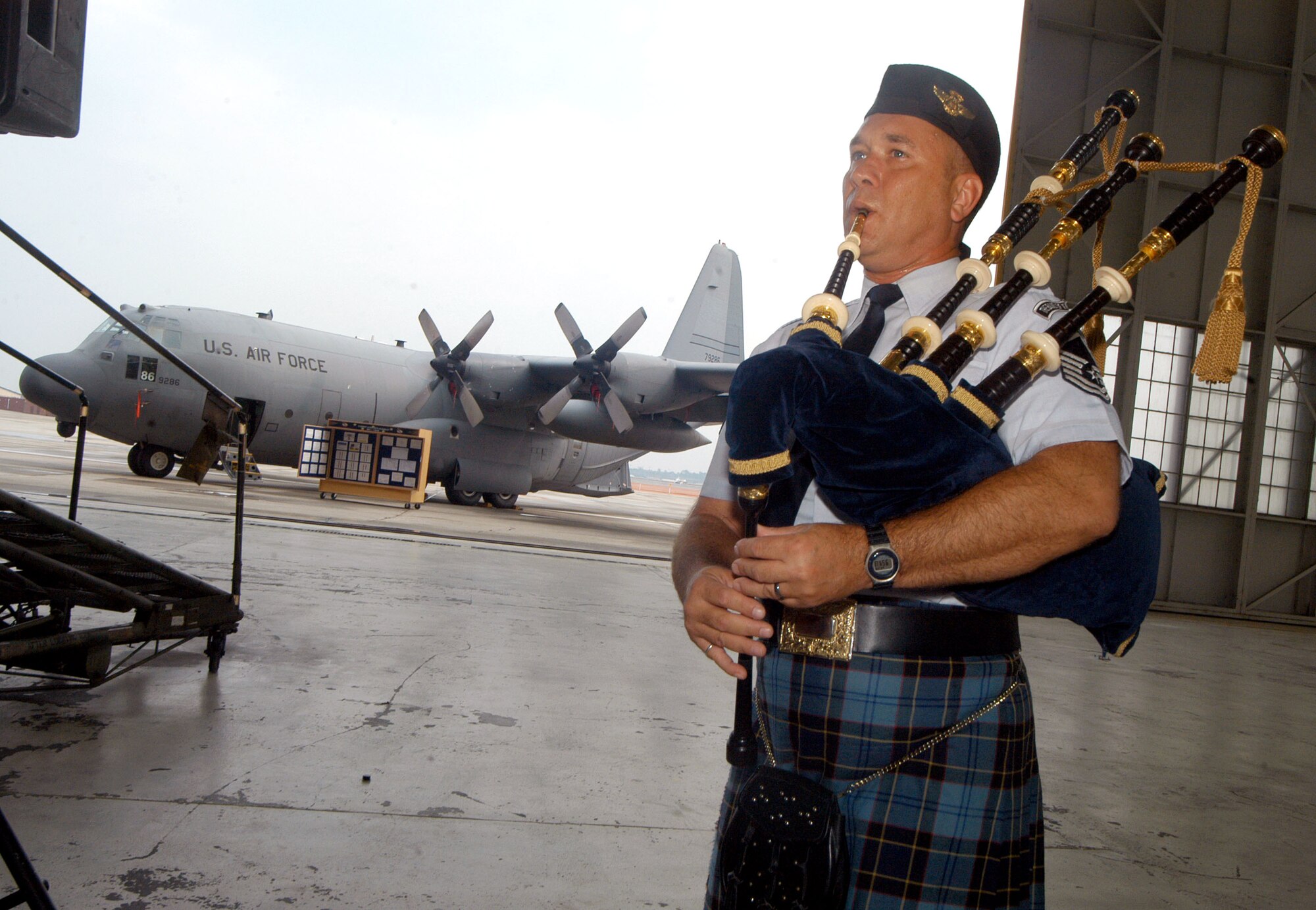Master Sgt. Scott Gunn plays the bagpipes at the roll-out ceremony for the MC-130W at Robins Air Force Base, Ga., on Wednesday, June 28. Sergeant Gunn is assigned to the Band of the U.S. Air Force Reserve. The highly modified C-130 will replace special operations aircraft lost in combat. (U.S. Air Force photo/Sue Sapp)
