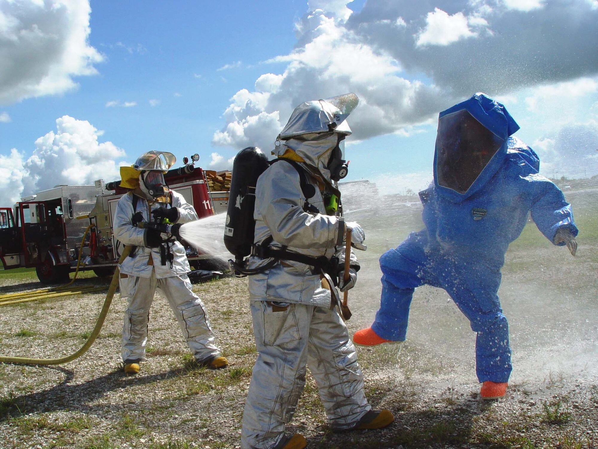 Firefighters from the 482nd Civil Engineering Squadron practice decontamination procedures during hazardous materials training at Homestead Air Reserve Base, Fla. on June 9. Members of the base fire department train several times a year while wearing chemical and biological protective suits.  (US Air Force photo by Lisa Macias)