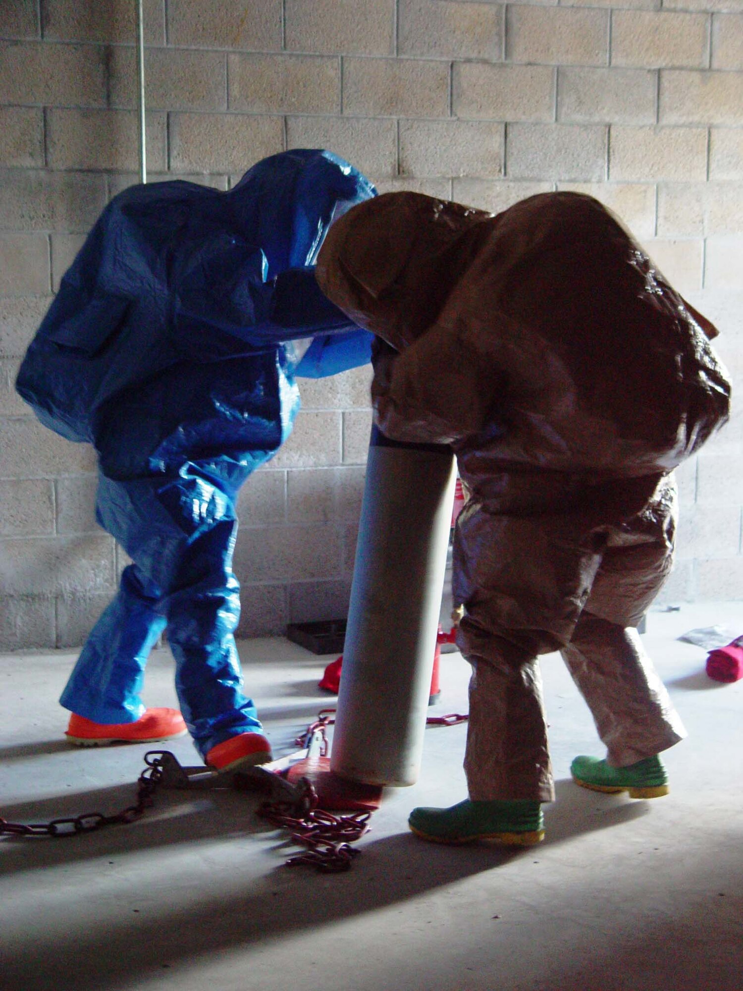 Firefighters from the 482nd Civil Engineering Squadron prepare to cap a simulated chlorine leak during hazardous materials training at Homestead Air Reserve Base, Fla. on June 9. Members of the base fire department train several times a year while wearing chemical and biological protective suits. The firefighters had 20 minutes from the initial call to contain the leak.  (US Air Force photo by Lisa Macias)                       