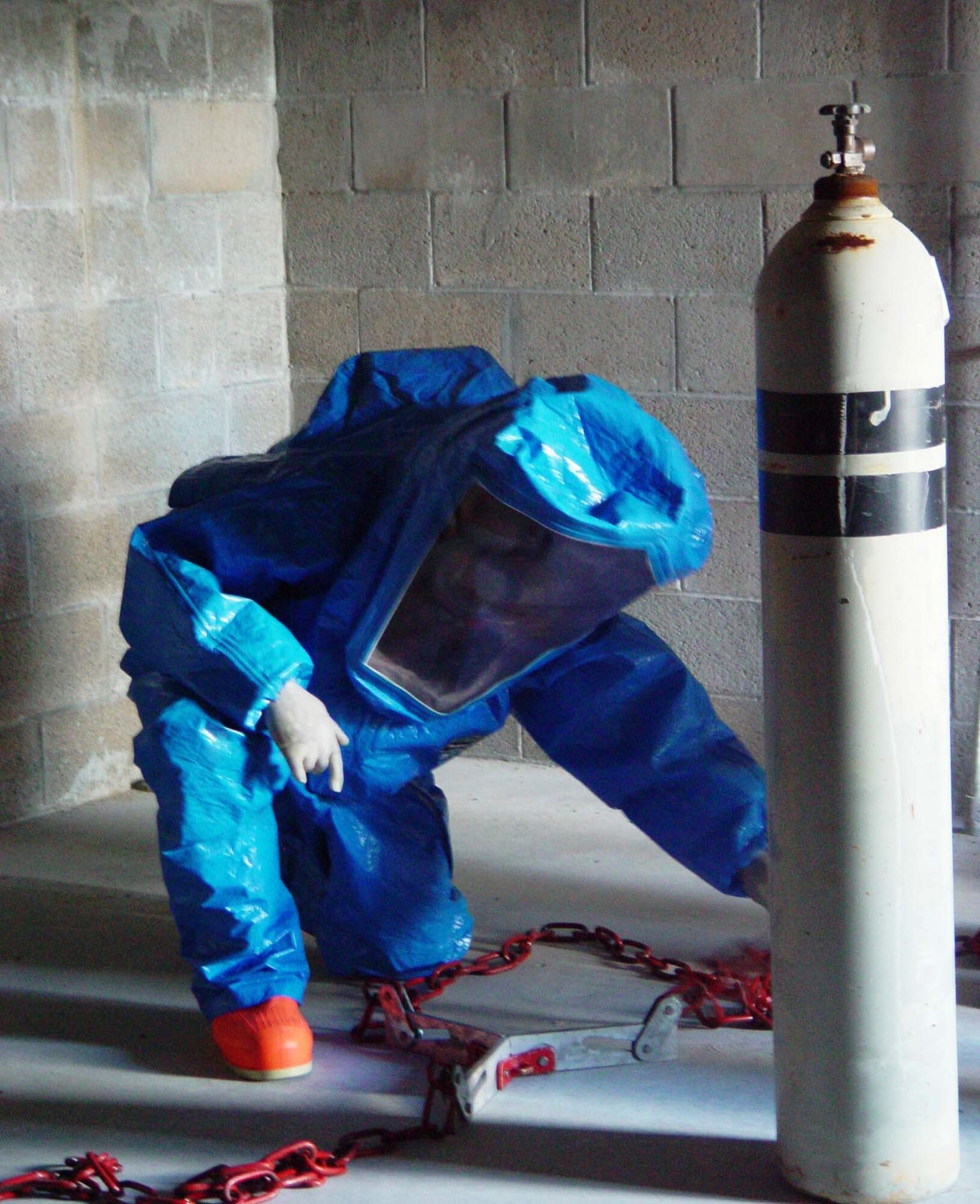A firefighter from the 482nd Civil Engineering Squadron prepares to cap a simulated chlorine leak during hazardous materials training at Homestead Air Reserve Base, Fla. on June 9. Members of the base fire department train several times a year while wearing chemical and biological protective suits.  The firefighters had 20 minutes from the initial call to contain the leak.  (US Air Force photo by Lisa Macias)