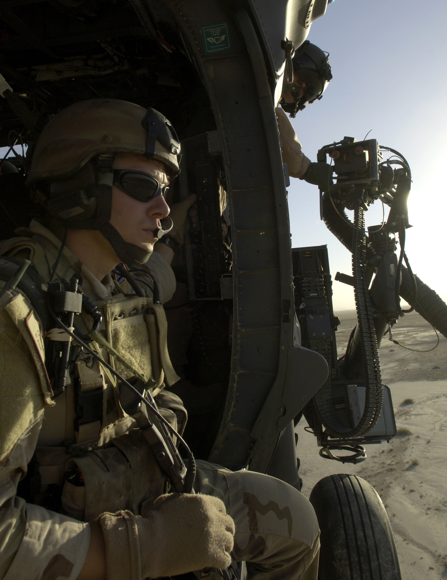 A pararescueman from the 33rd Expeditionary Rescue Squadron keeps watch out the door of an HH-60 Pave Hawk helicopter as it flies over Afghanistan June 11. The 33rd ERQS is the first squadron to have a combat-search-and-rescue mission and a medevac mission, and is based at Kandahar, Afghanistan. (U.S. Air Force photo/Senior Airman Brian Ferguson) 
