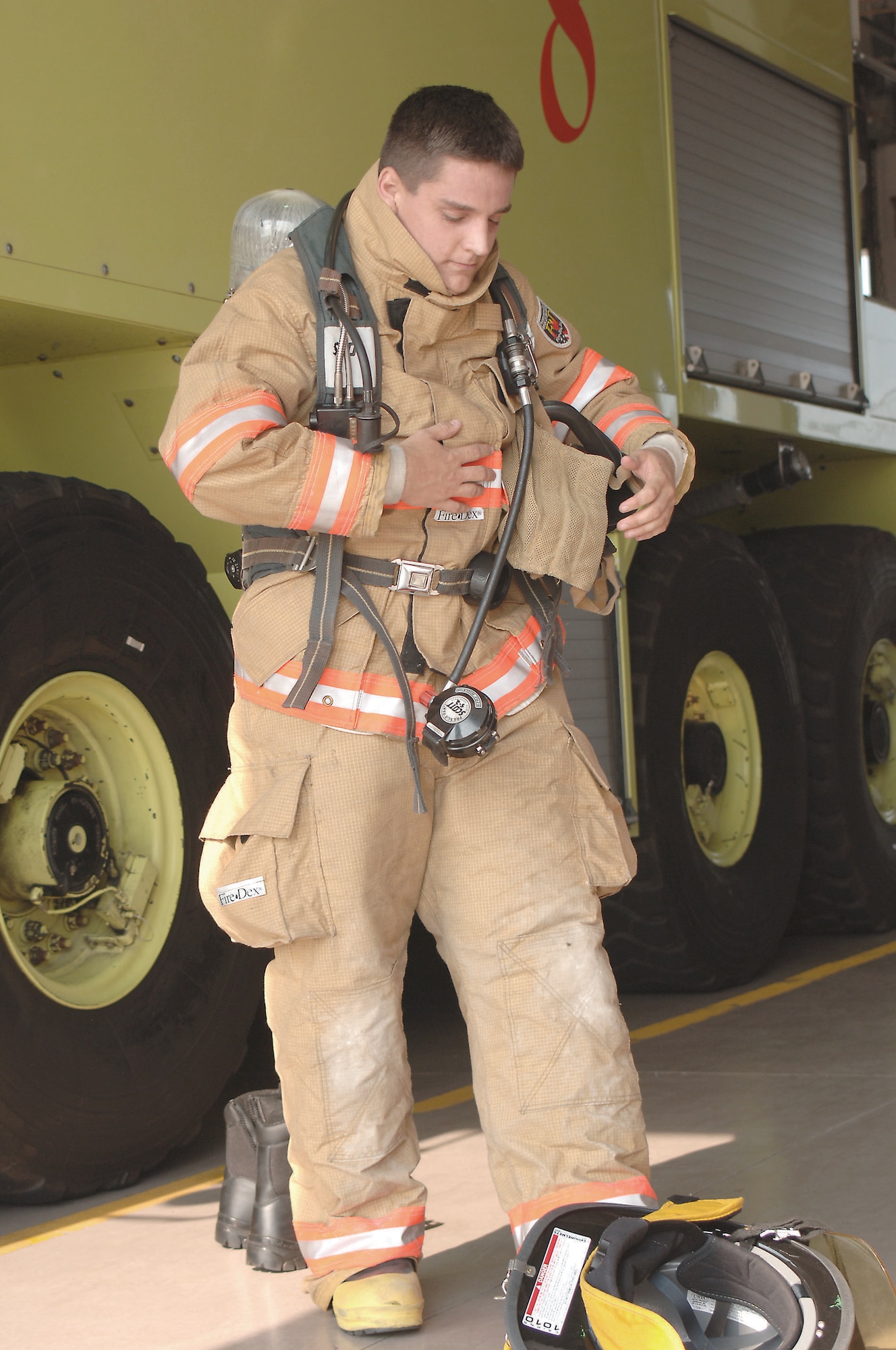 Airman Mark Molnar, 20th Civil Engineer Squadron fire fighter, demonstrates the proper wear of a fire suit for CAP members during their base-wide tour.   (U.S. Air Force Photo/Airman 1st Class Katherine Dodd)