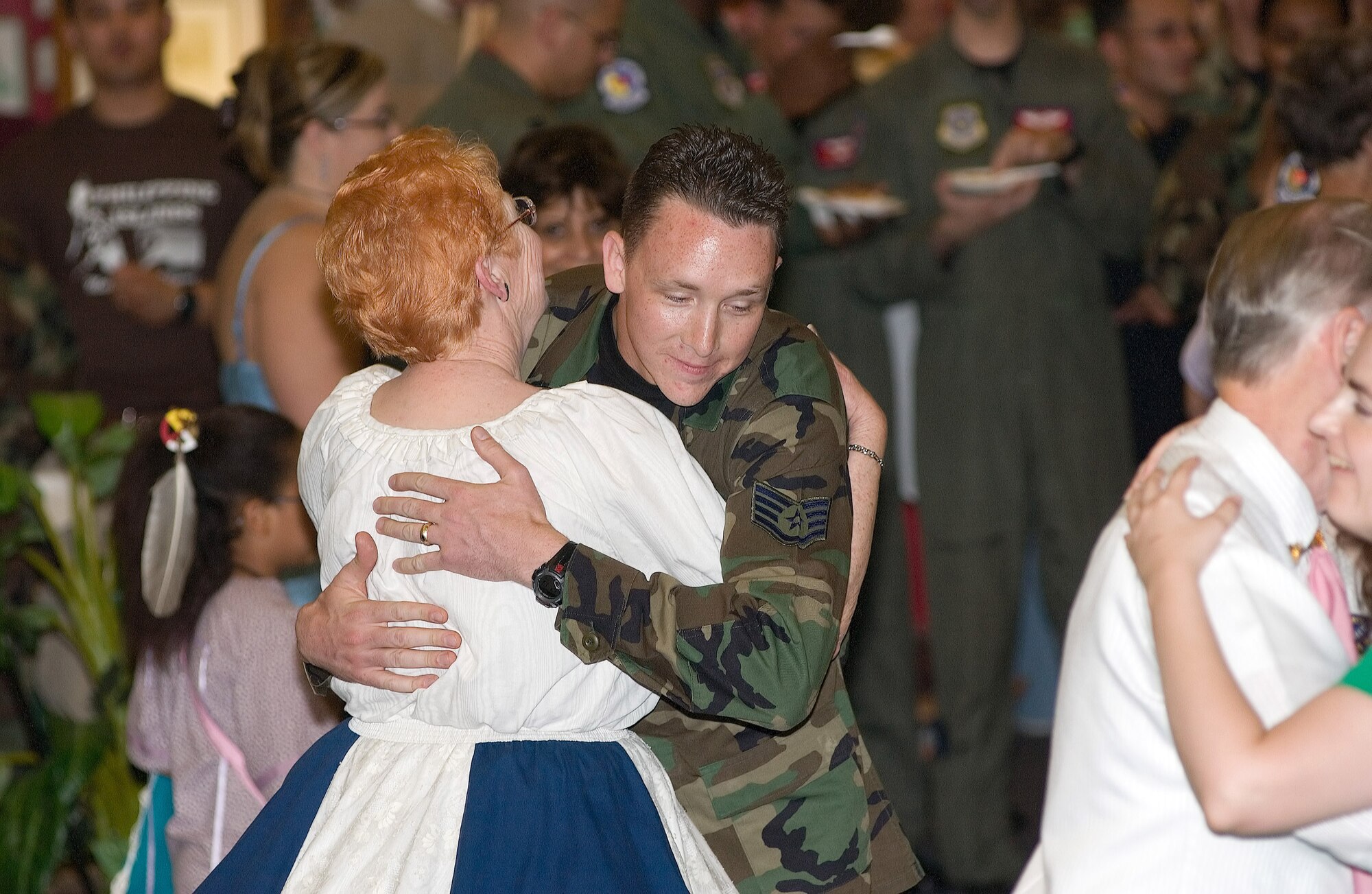 Staff Sgt. John Rocks, 436th Aeromedical-Dental Operations Squadron, square dances with a member of the Whirl-a-Ways Square Dancers at Dover's annual Multi-Cultural Expo 2006 at The Landings Club here June 23. (U.S. Air Force photo by Jason Minto)
