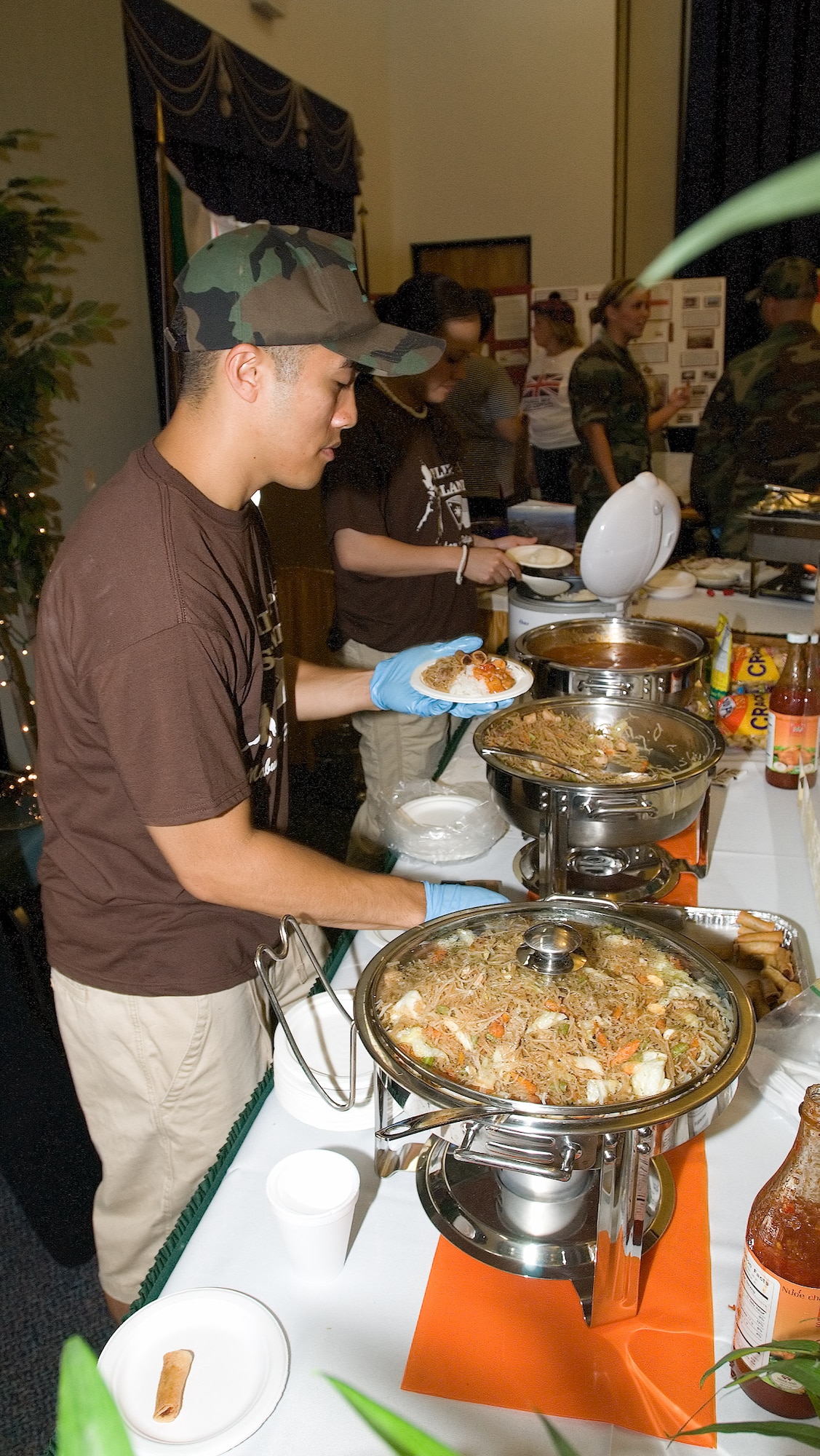 Staff Sgt. Angelo Dumanhog, 436th Logistics Readiness Squadron, cooks a Filipino cuisine at the Philippines booth during Dover's 2006 Multi-Cultural Expo at The Landings Club June 23. (U.S. Air Force photo by Jason Minto)