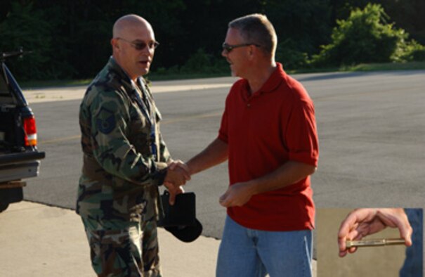 ANDREWS AIR FORCE BASE, Md. -- Master Sgt. David Hanson, 459th ARW Quality Assurance, congratulates MSgt. R.C. Bowman, 459th Aircraft Structural Maintenance, for finding the Golden Bolt.  Golden Bolt is a Department of Defense authorized program designed to reenergize Foreign Object Debris and Foreign Object Damage awareness.  This Air Force Reserve Command unit kicked off the program on June 14, on the 459th Air Refueling Wing flightline.  It is not announced when or where the bolt will be hidden within the wing.  Bowman will receive a time-off award for finding the Golden Bolt. 