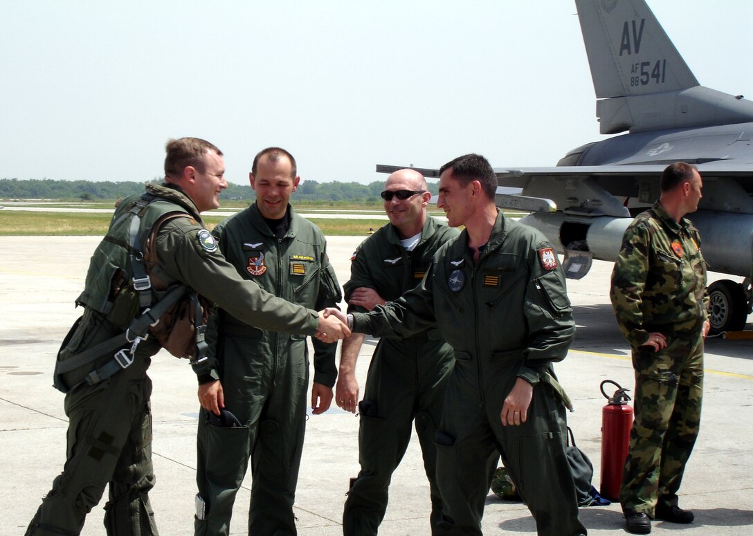 Maj. Andrew Wiles, 555th Fighter Squadron pilot, left, greets members of the Serbian air force during a visit to Batajnica Air Base, Serbia June 22.
