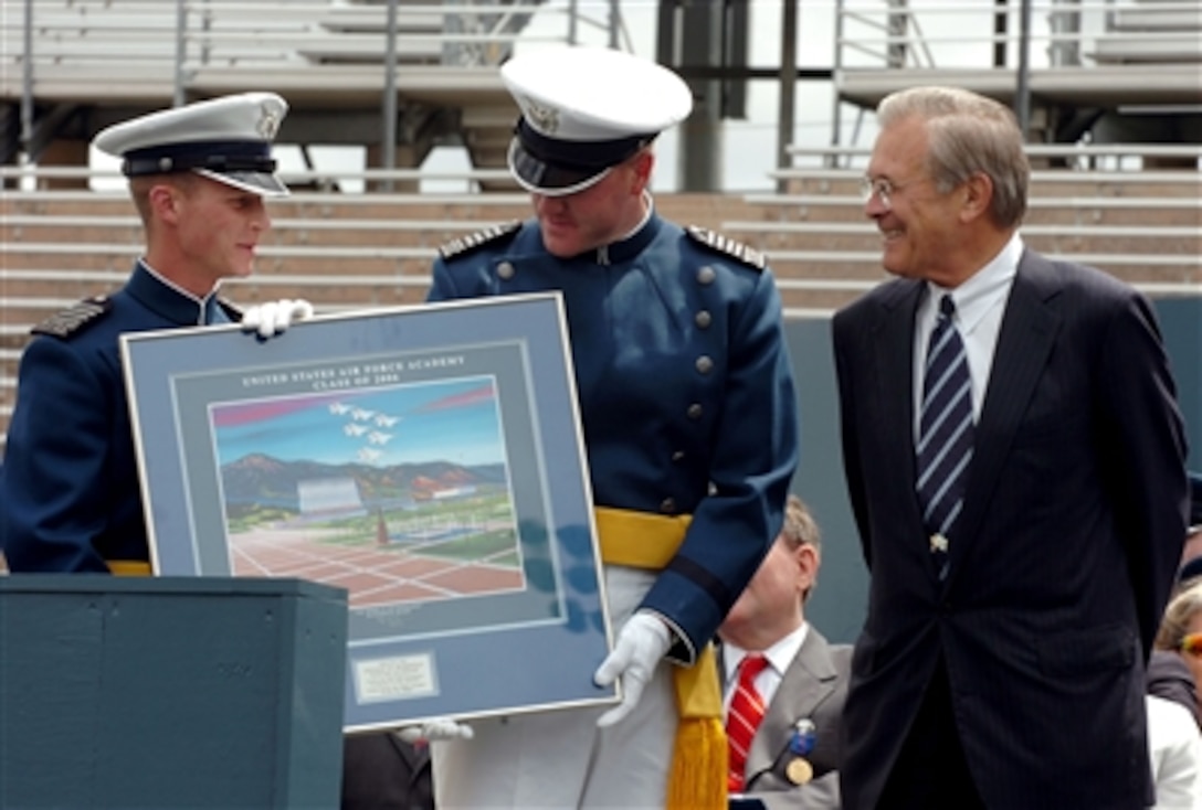 Secretary of Defense Donald H. Rumsfeld is presented a thank you gift after delivering his commencement speech to the 2006 graduating class of the U.S. Air Force Academy in Colorado Springs, Colo., May 31, 2006.
