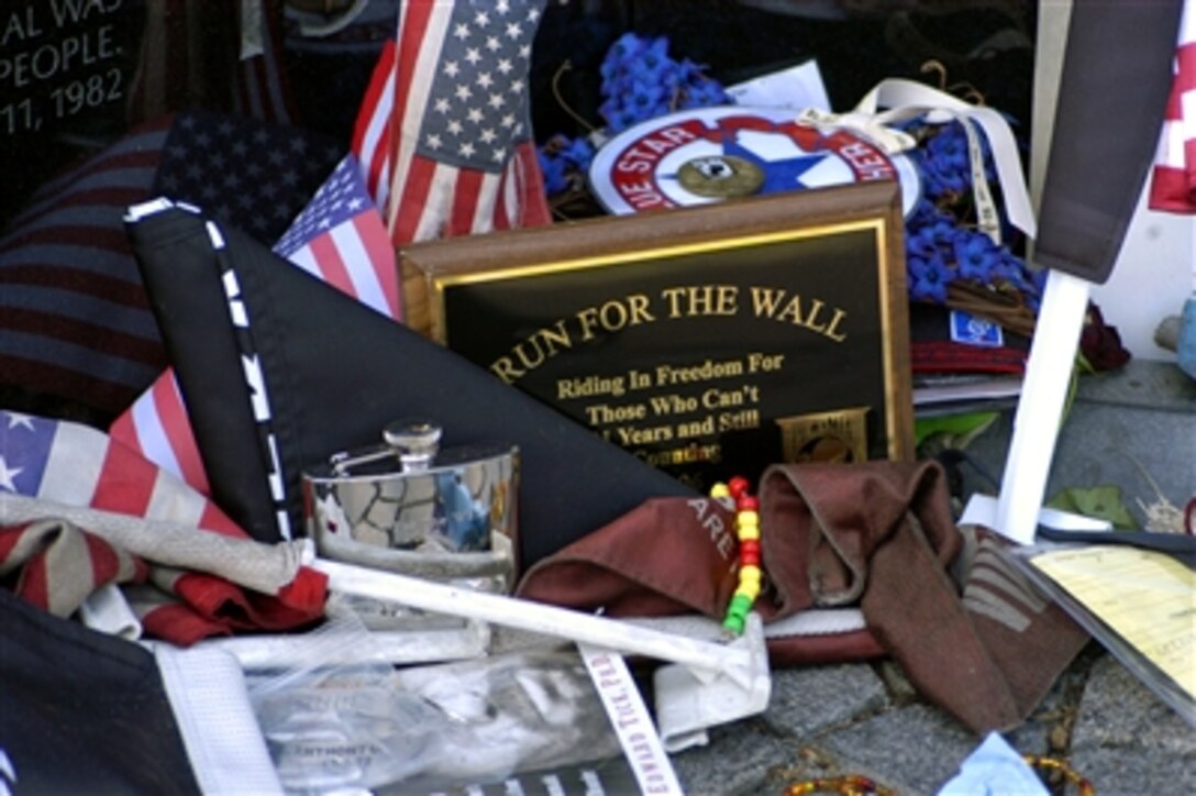 A small display of American flags and keepsake articles are left along the Vietnam Veterans Memorial, May 28, 2006, during the Memorial Day holiday weekend by 2006 “Rolling Thunder – The Run for the Wall” participants. Rolling Thunder began in 1987 by former U.S. Army Sgt. Artie Muller and a group of friends to recognize and honor all U.S. military veterans especially the POWs and those who are missing in action.