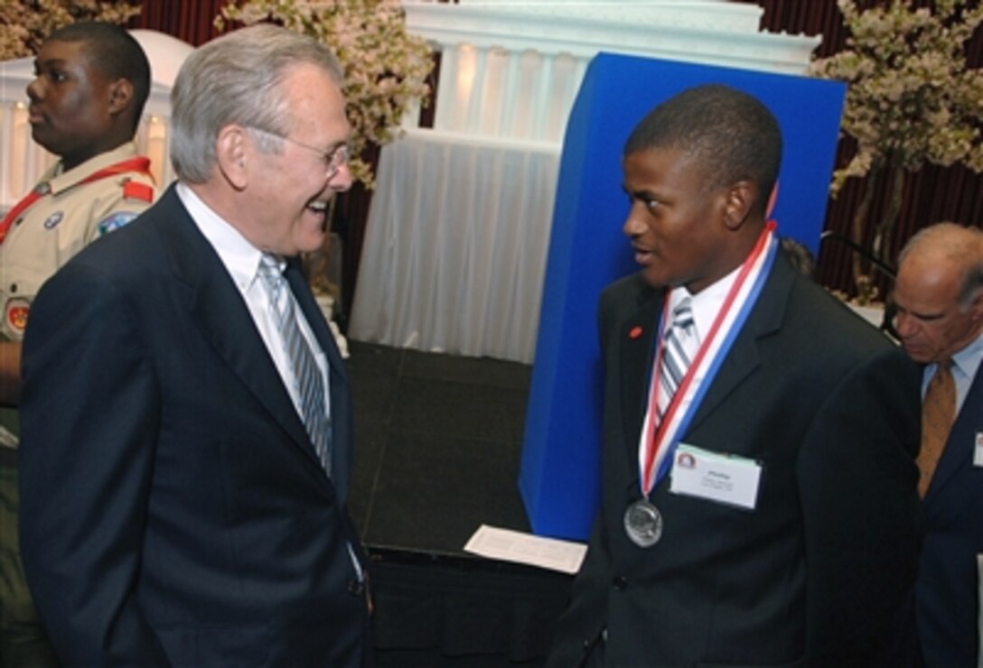 Defense Secretary Donald H. Rumsfeld speaks with Eagle Scout Phillip D. Stewart, winner of the Young American Award, at the Golden Buffalo Awards at the Marriott Wardman Park in Washington, D.C., May 25, 2006. Rumsfeld was presented the Golden Buffalo, the Boy Scout's highest commendation. It is presented to those who give truly noteworthy and extraordinary service to youth.