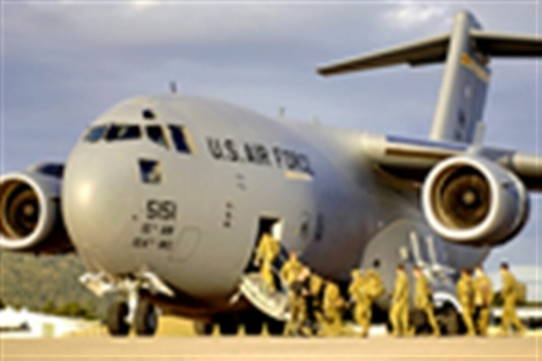 Australian Defense Forces board a C-17 Globemaster III at Royal Australian Air Force Base Townsville, Australia, May 30, 2006. Two C-17s from the 15th Airlift Wing and the Hawaii Air National Guard's 154th Wing at Hickam Air Force Base, Hawaii, are helping the Australian Defense Force reposition its forces in Australia to better support peace operations in East Timor.