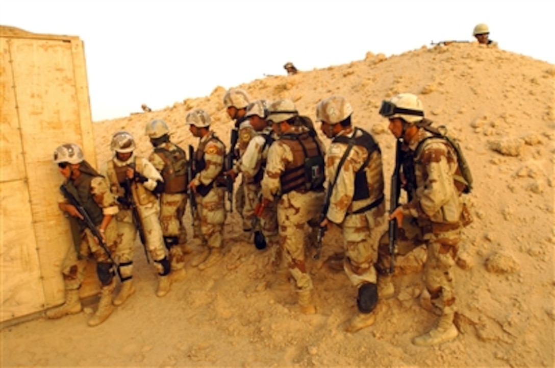 Local Iraqi Army soldiers set up a cordon and prepare to enter a close-quarters battle house during training at Forward Operating Base Duke near Najaf, Iraq, May 14, 2006.