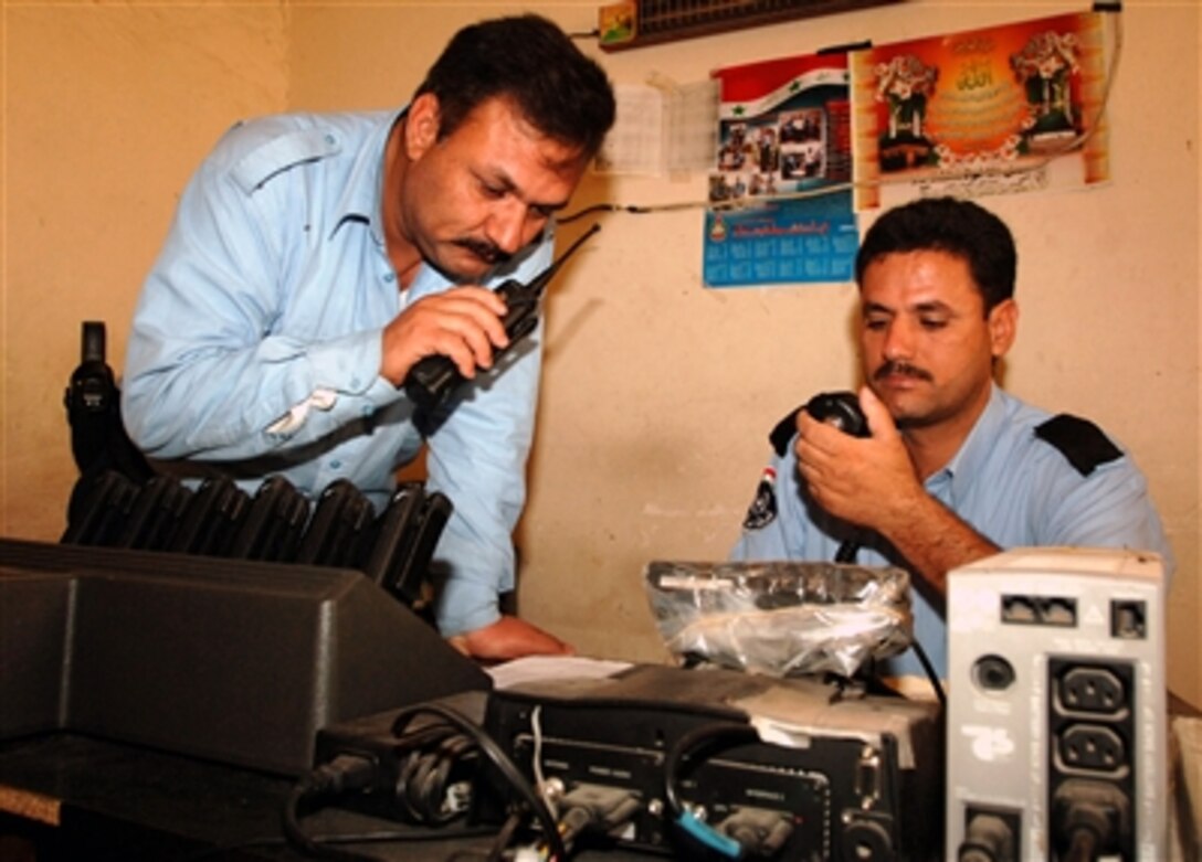 Iraqi police officers talk on the radio at the Al-Taji Police Station, April 17, 2006. Soldiers of the 463rd Military Police Company at Camp Liberty, Iraq, trained the Iraqi officers and make daily checks to ensure they are providing the best service to the Iraqi people. 