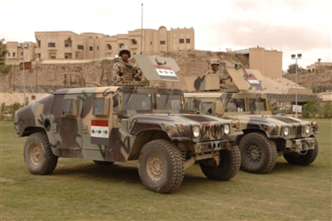 UIraqi soldiers of 1st Brigade, 4th Iraqi Army Division ride in up-armored Humvees during an assumption of command ceremony at Forward Operating Base Danger, Iraq, April 3, 2006. The 1st Brigade took command of the Samarra and Tikrit, Iraq, battlespace from the U.S. Army 3rd Brigade Combat Team. 