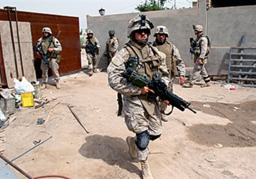 U.S. Marines of 3-2-1 Military Transition Team, 3rd Battalion, 8th Marines, and the Iraqi Army patrol near the Government Center in Ar Ramadi, Iraq, May 2, 2006.
