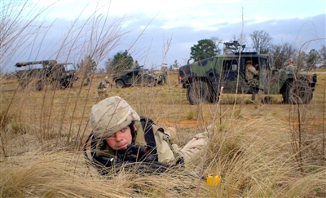 U.S. Air Force Senior Airman Tom Romano guards a convoy's perimeter during combat training at Fort Bragg, N.C., on March 27, 2006, before deploying to Afghanistan. Romano volunteered for a year-long deployment with the Bagram Provincial Reconstruction Team. He is a security forces specialist from Minot Air Force Base, N.D. 