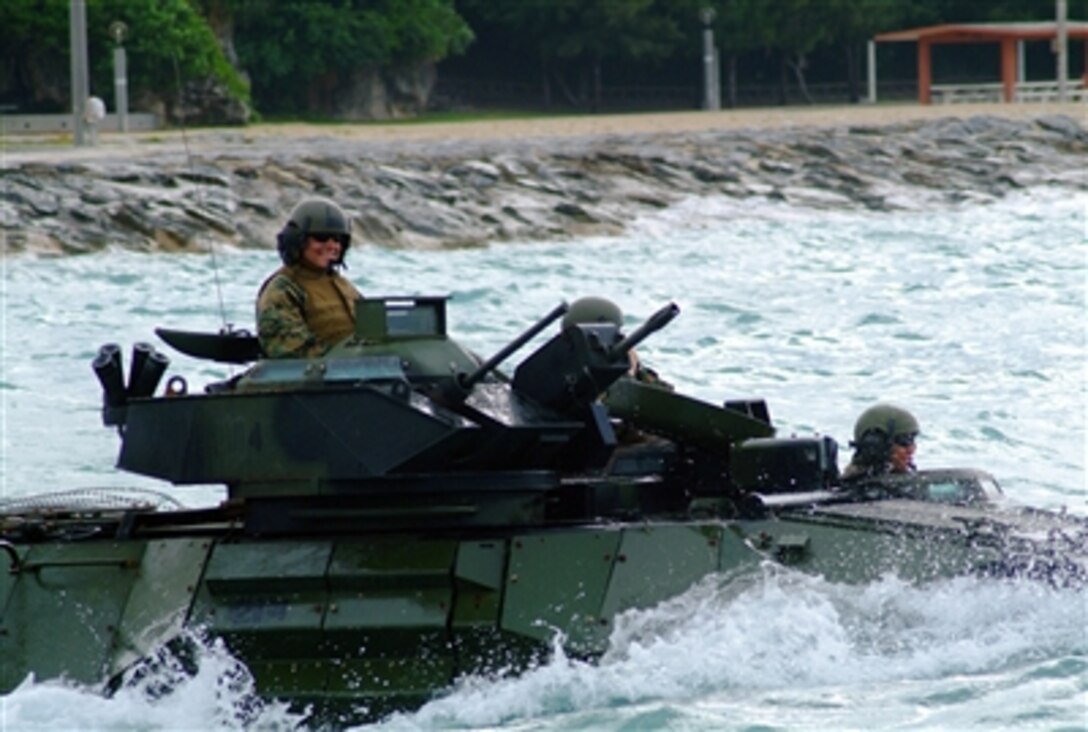U.S. Marines in an amphibious assault vehicle from the 31st Marine Expeditionary Unit, approaches the well deck of the amphibious dock landing ship USS Harpers Ferry off the coast of White Beach, Okinawa, Japan, March 22, 2006.