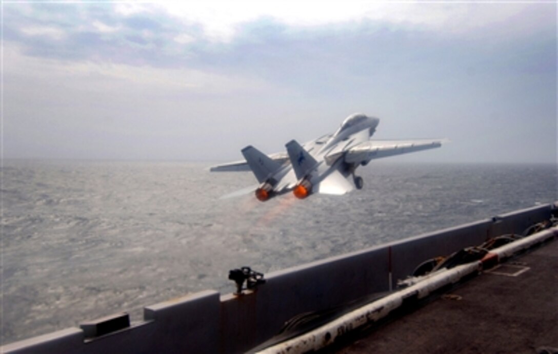 U.S. Navy Lt. Ken Hockycko and Lt. Roy Emanuel, F-14D Tomcat pilots assigned to the "Black Lions" of Fighter Squadron 213, launch from the flight deck of the aircraft carrier USS Theodore Roosevelt in the Atlantic Ocean, March 10, 2006. Fighter Squadrons 213 and 31 are completing their final deployment flying the F-14 Tomcat and this takeoff marks the final launch of an F-14 on deployment. 