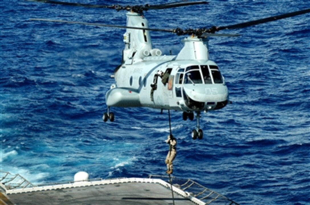 A U.S. Marine fast ropes from a CH-46 Sea Knight helicopter to the deck of the USS Peleliu during a training exercise, March 8, 2006. The Marine is assigned to Company C, Battalion Landing Team 1st Battalion, 4th Marine Regiment, 11th Marine Expeditionary Unit (Special Operations Capable), Camp Pendleton, Calif. The unit is on a six-month deployment throughout the western Pacific Ocean and Persian Gulf in support of the global war on terrorism.