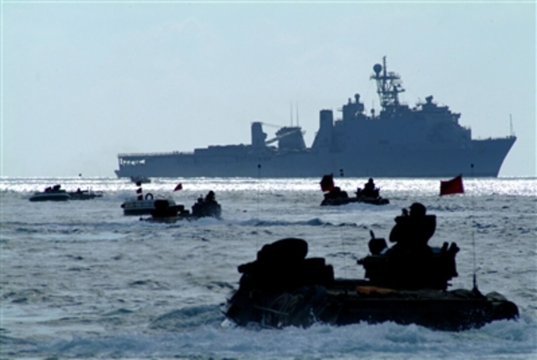 U.S. Marine Corps armored amphibious vehicles from the 2nd Battalion, 5th Marine Regiment, Battalion Landing Team leave the beach on the island of Iwo Jima to return to the amphibious dock landing ship USS Harpers Ferry in the Philippine Sea, March 8, 2006. The Harpers Ferry, along with the amphibious assault ship USS Essex and elements of the 31st Marine Expeditionary Unit, are visiting Iwo Jima to commemorate the 61st anniversary of the famous Pacific War battle in February 1945. 