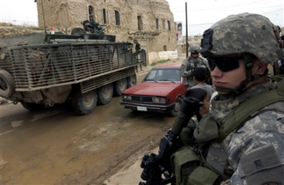 U.S. Army Spc. Jimmy Wilkes provides security during an operation in Tall Kayf, Iraq, March 1, 2006. Wilkes is from the 2nd Battalion, 1st Infantry Regiment, 172nd Stryker Brigade Combat Team.