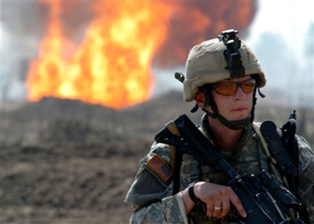 U.S. Army Staff Sgt. Dave Fitzgerald maintains perimeter security during a reconnaissance patrol March 1, 2006, at the site of an insurgent attack on an oil pipeline near Taji, Iraq. Fitzgerald is assigned to the 66th Armored Battalion, 1st Brigade, 4th Infantry Division. 
