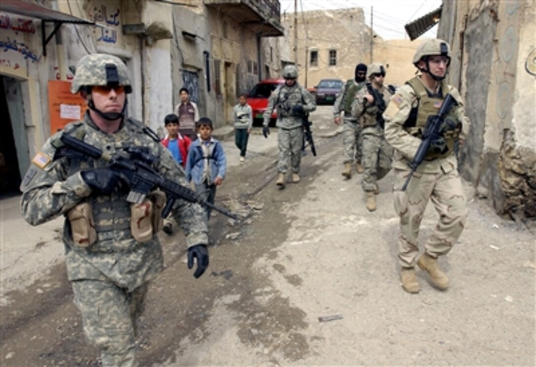U.S. Army soldiers from the 2nd Battalion, 1st Infantry Regiment, 172nd Stryker Brigade Combat Team patrol the streets of Tall Kayf, Iraq, March 1, 2006. 