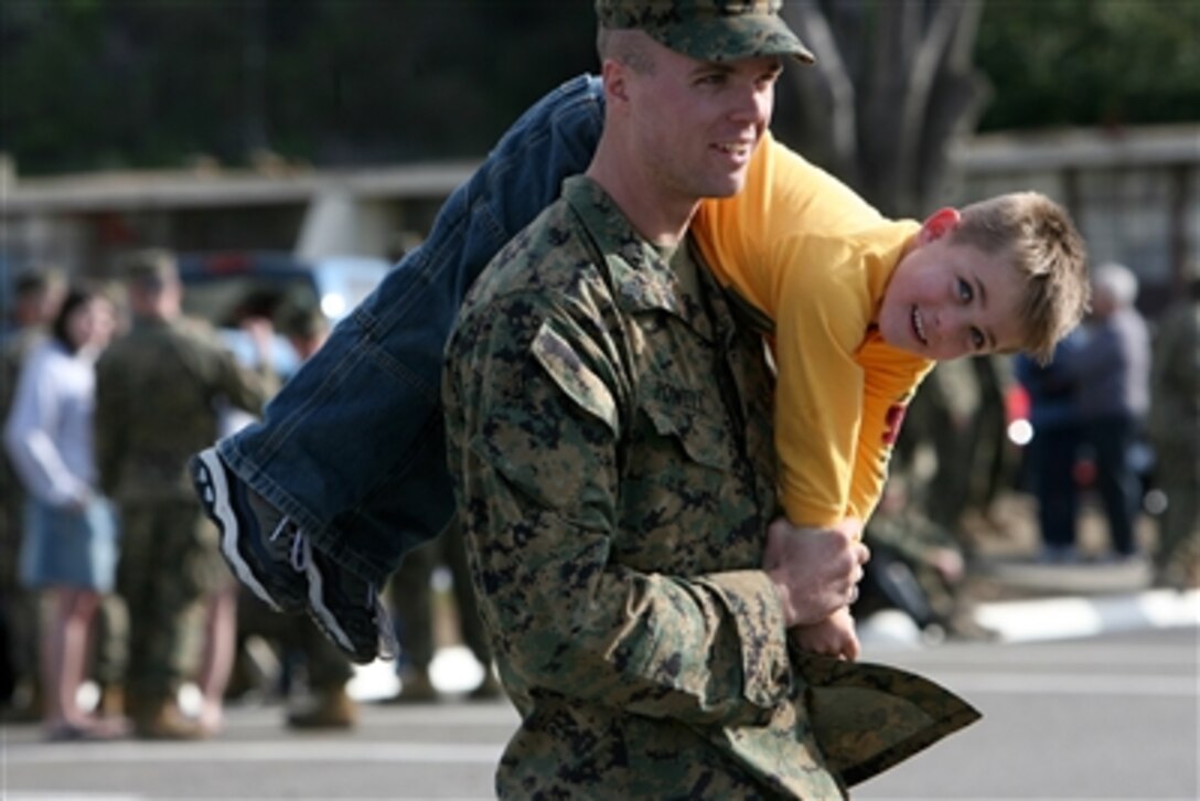 U.S. Marine Sgt. James T. Powell, an ammunition technician with 2nd Battalion, 1st Marine Regiment, "carries on" with his 5-year-old son, Kyle at the unit's homecoming at Camp Horno, Camp Pendleton, Calif., Feb. 19. His unit and the 13th Marine Expeditionary Unit spent seven months afloat conducting humanitarian missions in Egypt and security and stability operations in Iraq. 