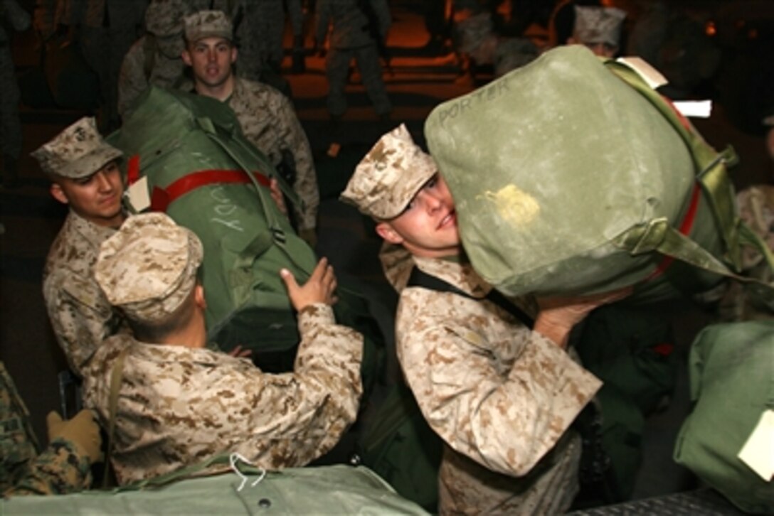 U.S. Marines with the Combat Logistics Battalion 7 load seabags into a truck as the unit departs for a seven-month tour in Iraq, Feb. 10, 2006. 